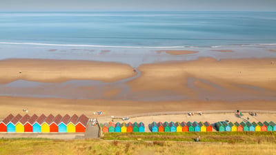 Bing wallpaper July 29, 2021. Beach huts on West Cliff Beach, Whitby, North Yorkshire (© Robert Harding World Imagery/Offset)