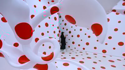 Bing wallpaper April 14, 2019. A woman looks at Yayoi Kusama's 'With All My Love for The Tulips, I Pray Forever (2011)' (© Timothy A. Clary/Getty Images)